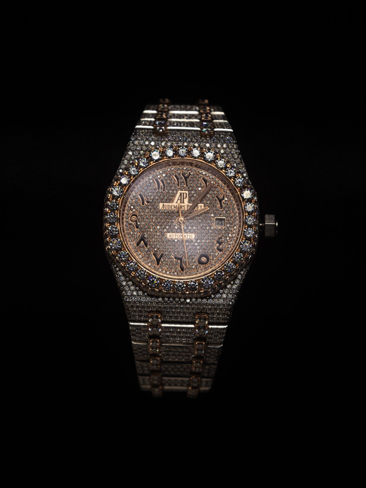 Diamond-set wristwatch photographed against a black background.